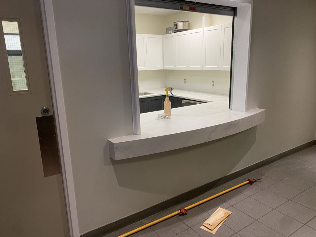 A broken wall shelf with pieces on the floor.